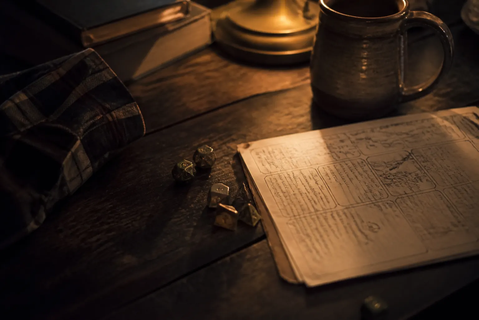 A tabletop with dice, seedlings, mugs, snacks, and a folded flannel shirt